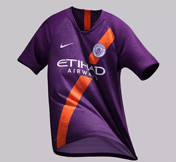 Man city purple top and orange kit
