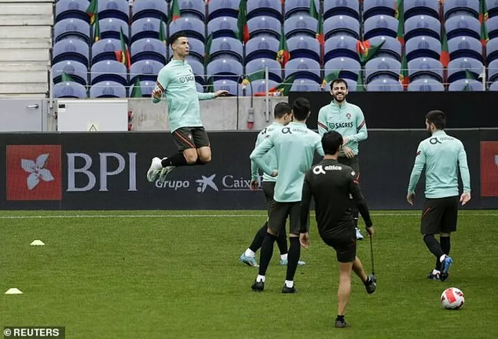 Portugal's Cristiano Ronaldo heads the ball during a team training