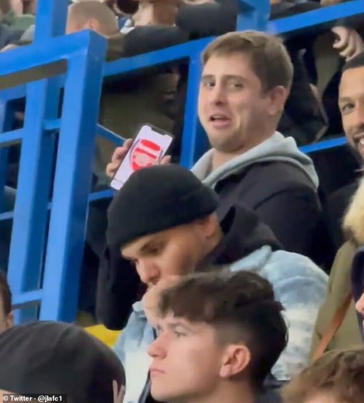 A cheeky Arsenal fan is hilariously spotted 'hiding' in the Chelsea end ...