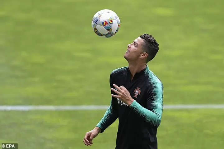 Portugal's Cristiano Ronaldo heads the ball during a team training