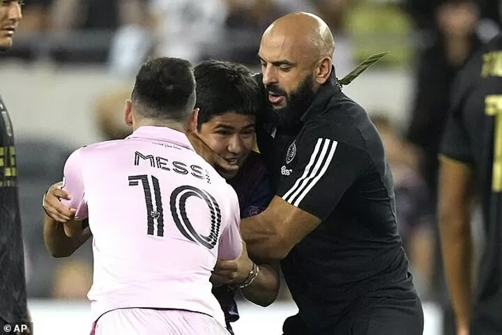 Lionel Messi's security pulls pitch invader around the neck and yanks him away from the Argentine star