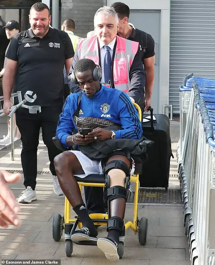 Bailly arrives back in Manchester in full leg brace and wheelchair