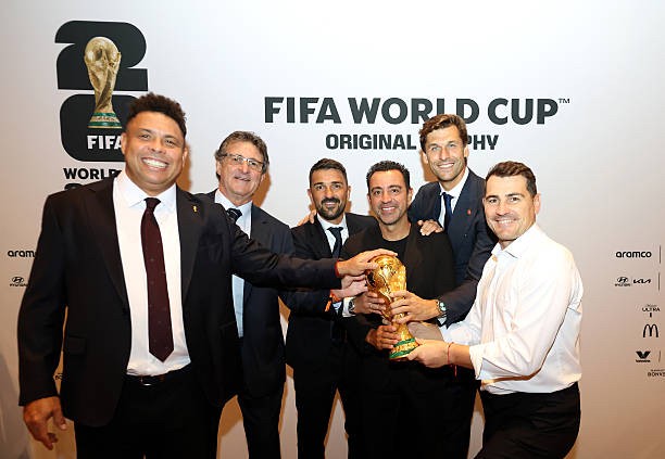 Who will lift the World Cup tonight? Football legends pose with the trophy before the final