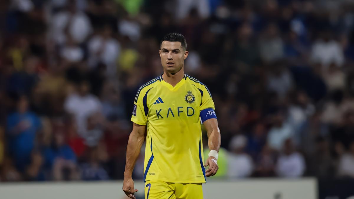 Ronaldo smiles and leans in curiously to check teammate Danilo's tactics board